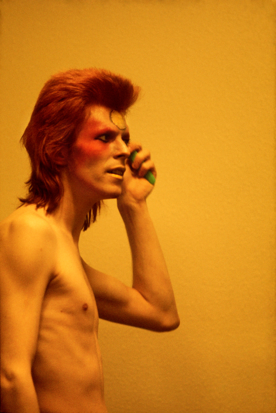 David Bowie with Telephone, United Kingdom, 1973, photographed by Mick Rock.