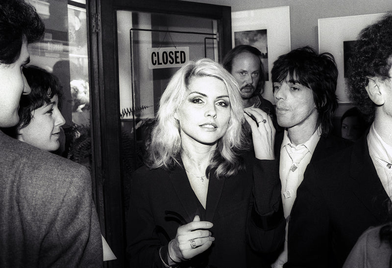 Radiant close-up of Debbie Harry with blue eye make-up and backlit hair, photographed by Martyn Goddard.