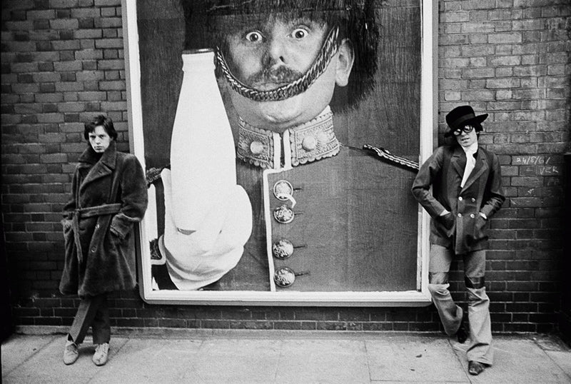 Mick Jagger and Keith Richards beside a Pinta milk poster, London, photographed by Michael Cooper, 1967.