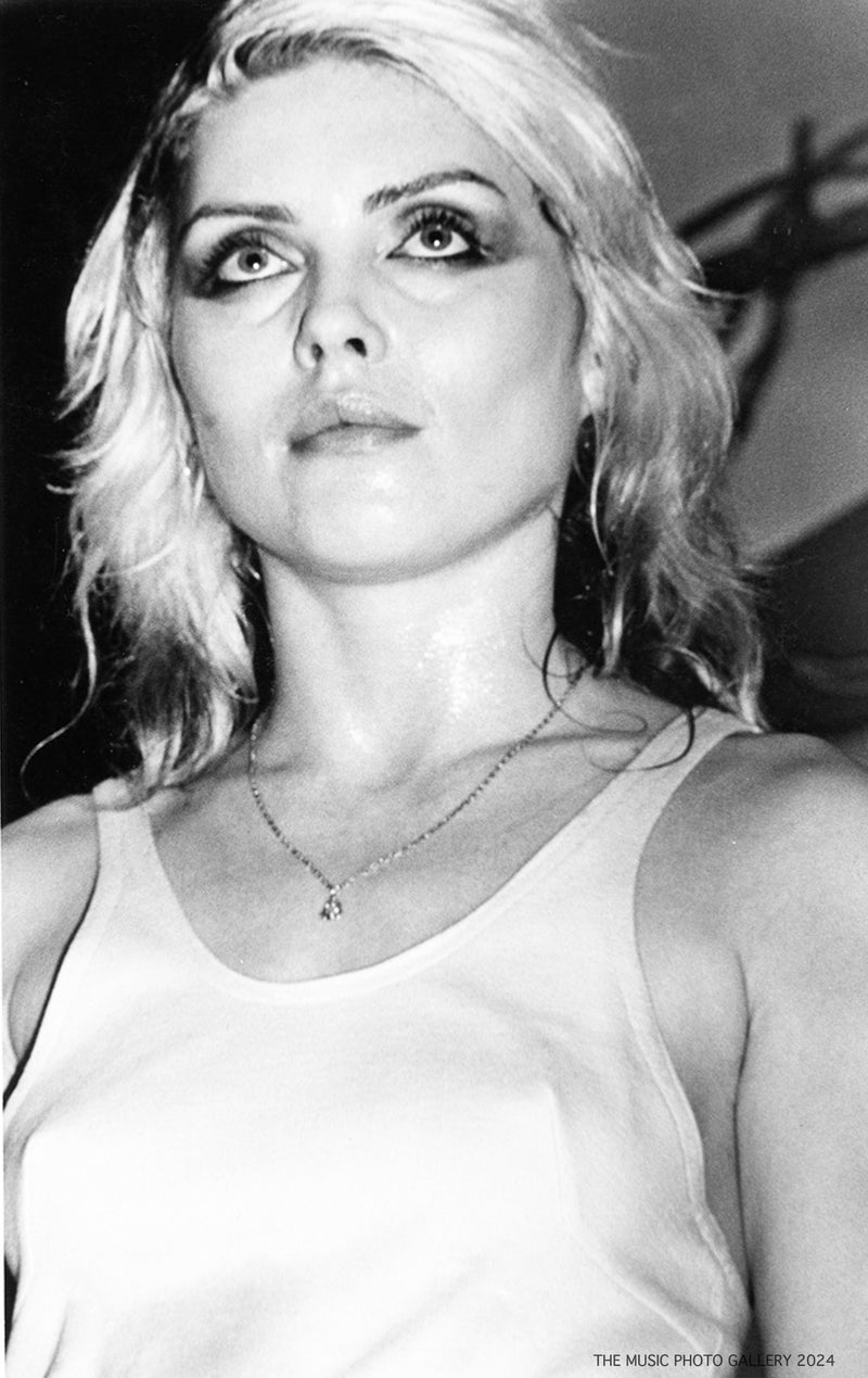 Debbie Harry looking upward during a performance, photographed by Ebet Roberts.