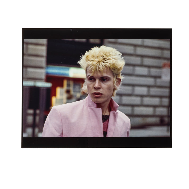 Billy Idol bleached and spiky on a New York street in a pale-pink jacket, photographed by Roberta Bayley, 1978.