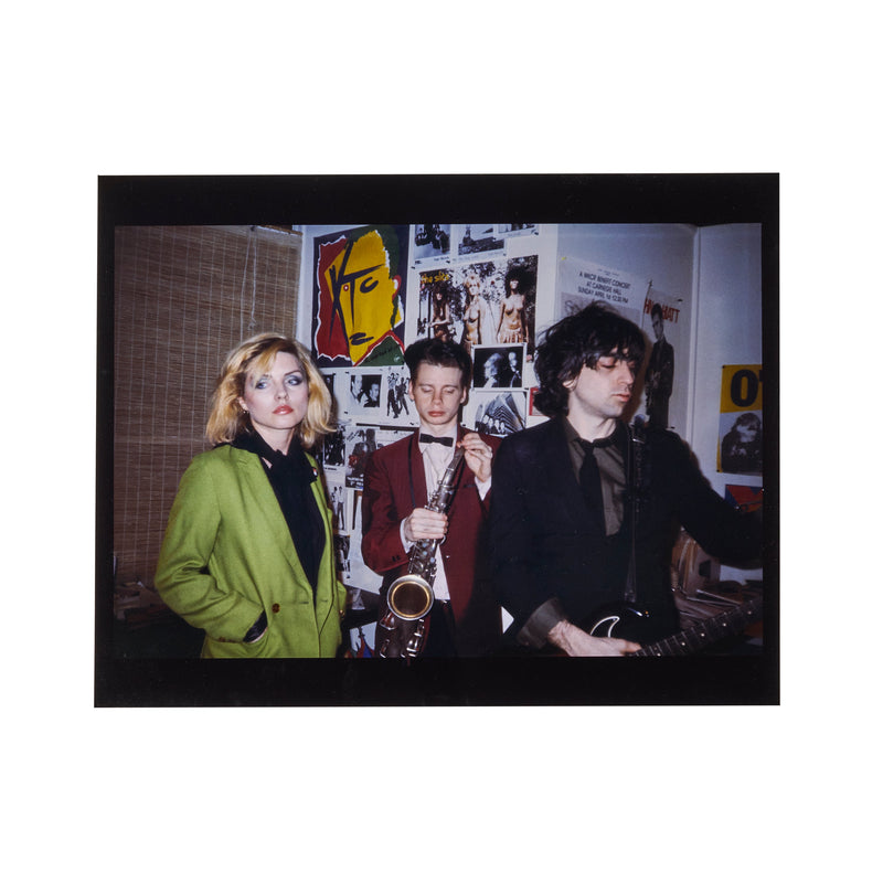 Debbie Harry, James Chance and Chris Stein against a poster-covered wall, photographed by Roberta Bayley, 1980.
