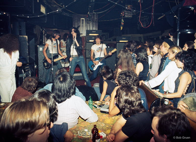 Ramones performing on stage at CBGB, New York City, 1976, photographed by Bob Gruen.