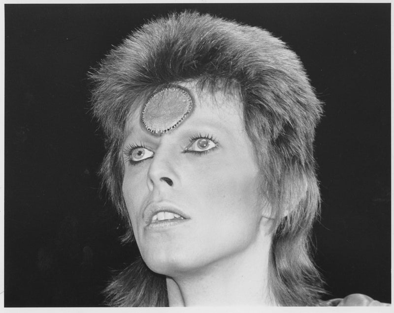 David Bowie under a single spotlight, 1972, photographed by Mick Rock. Unique vintage gelatin silver print.