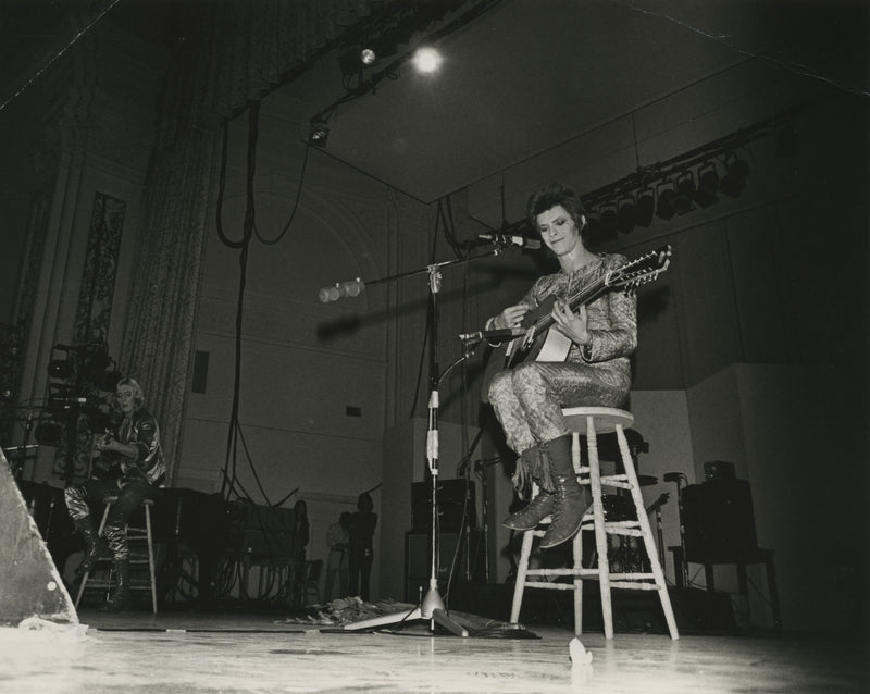 Black-and-white photograph of David Bowie performing at Oxford Town Hall in 1972, taken by Mick Rock — vintage gelatin silver print