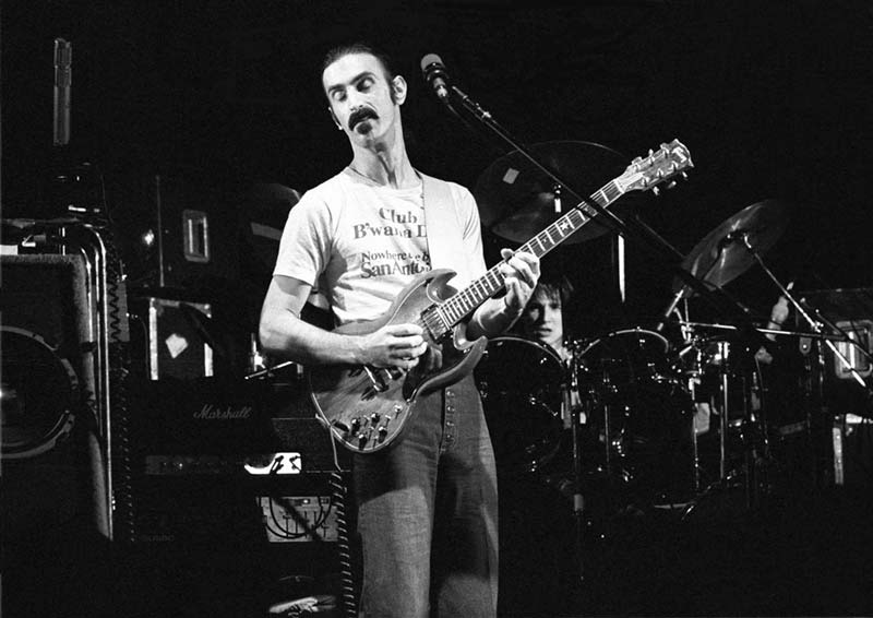 Frank Zappa performing live on stage with guitar, 1975. Photograph by Ian Dickson.