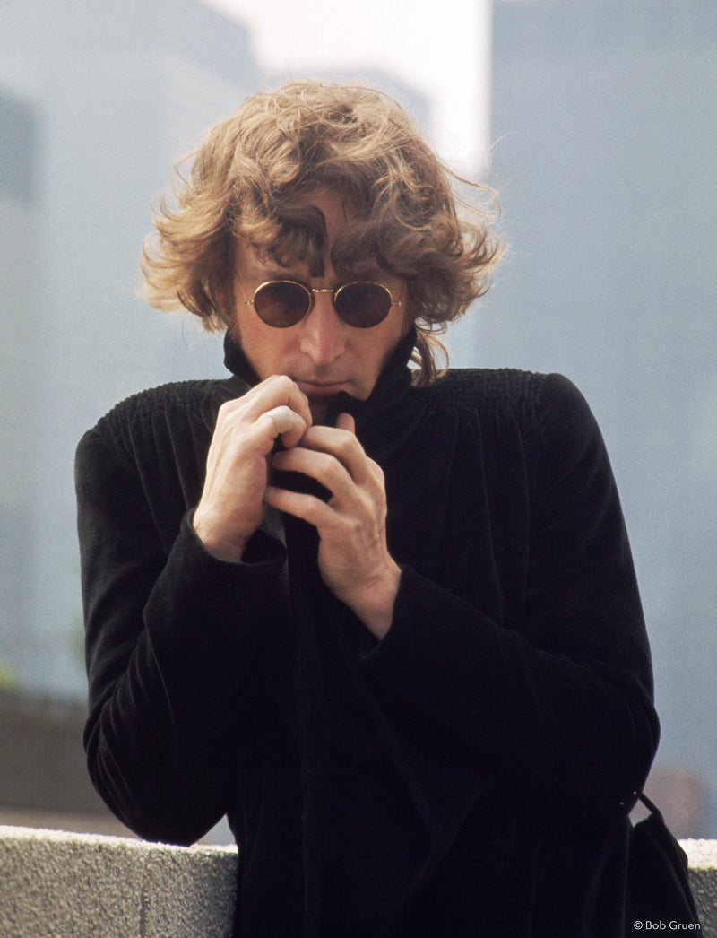 John Lennon making a playful gesture in New York City, 1974, photographed by Bob Gruen.
