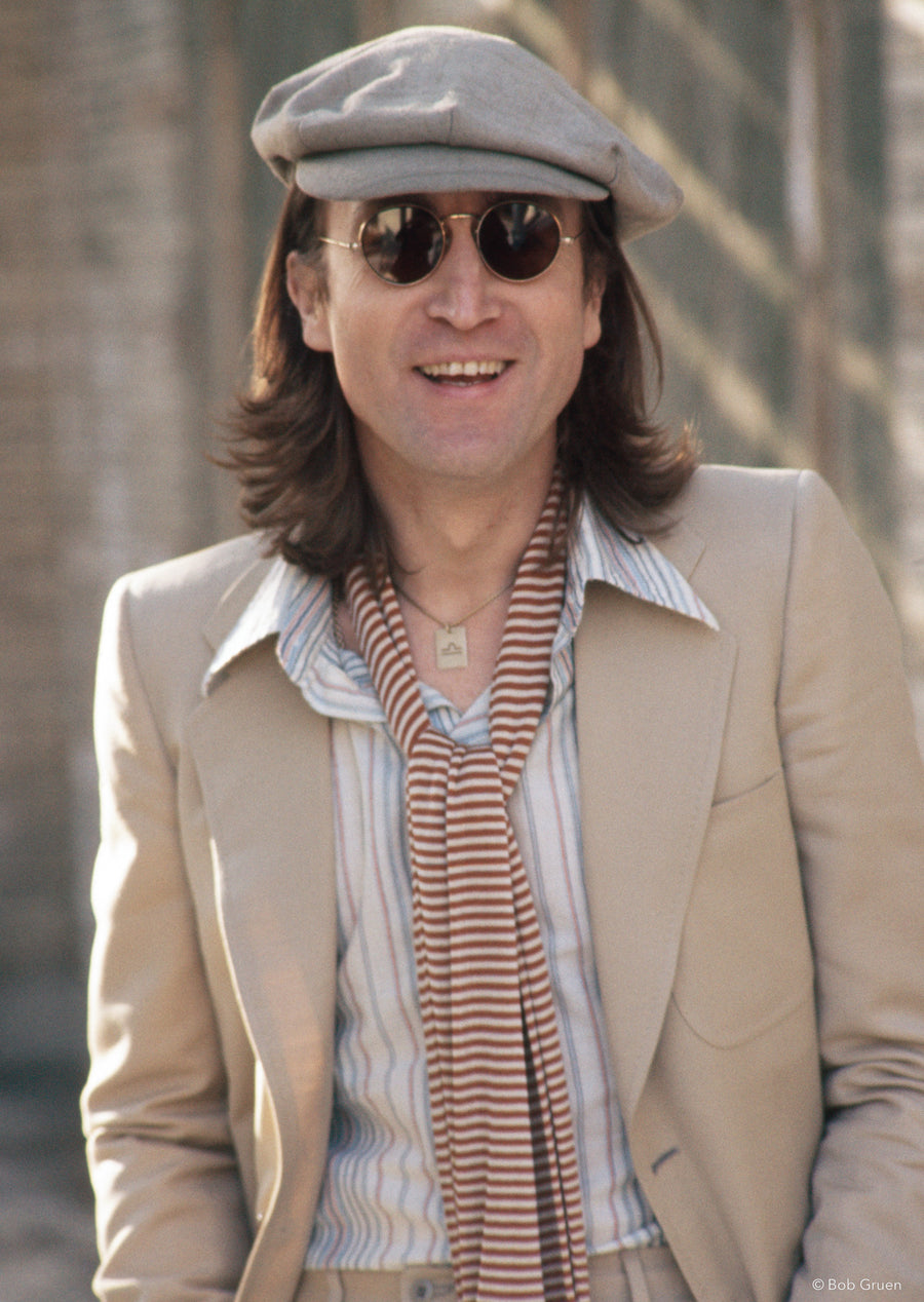 John Lennon wearing a beige suit at Untermyer Park in Yonkers, NY, 1975, photographed by Bob Gruen.