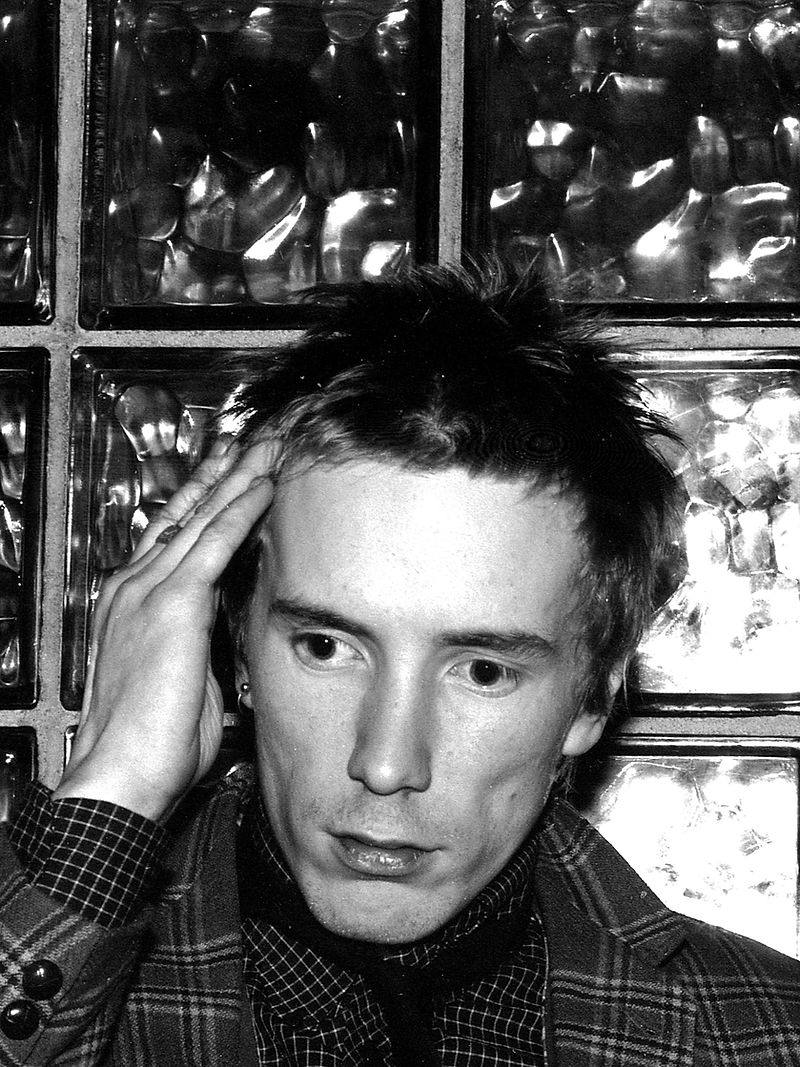John Lydon by the glass block wall, Chelsea, 1980, photographed by Sheila Rock.