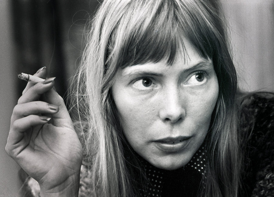 Joni Mitchell holding a cigarette during a close-up portrait in 1972. Photograph by Gijsbert Hanekroot.