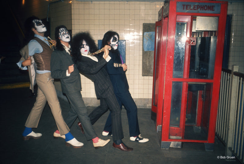 Members of Kiss entering a phone booth in New York City, 1974, photographed by Bob Gruen.