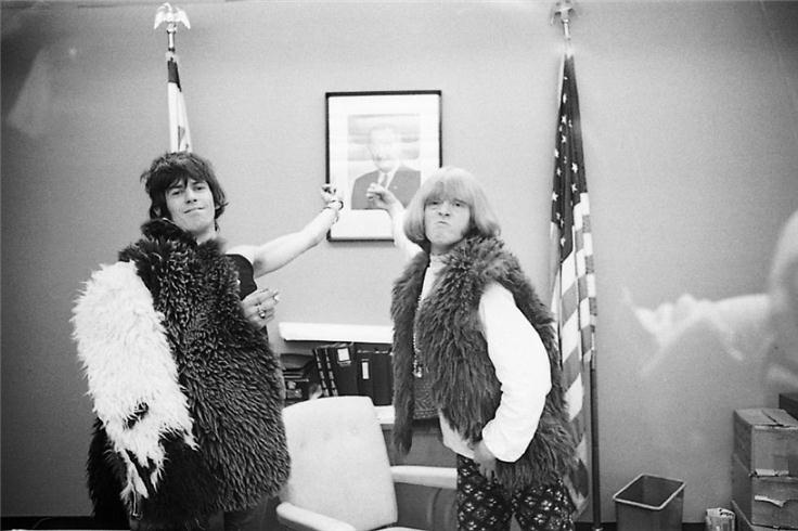Keith Richards and Brian Jones in an interrogation room at JFK Airport, New York, photographed by Michael Cooper, 1967.