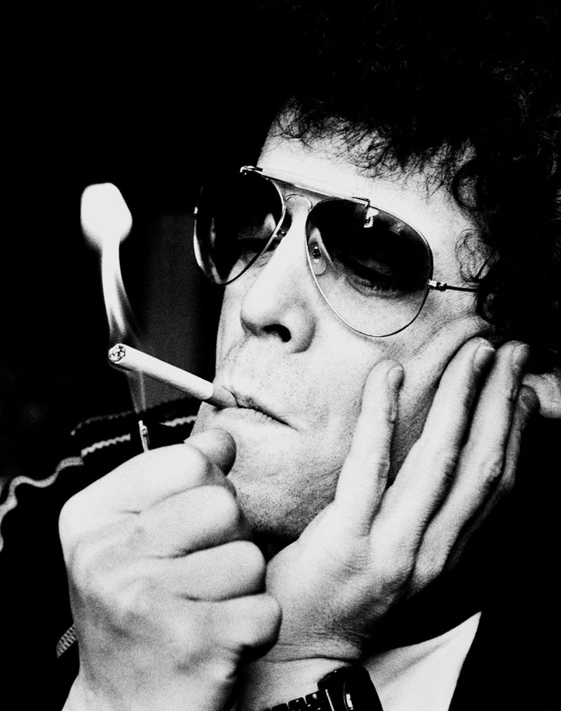 Lou Reed smoking with his face resting in one hand in 1972. Photograph by Gijsbert Hanekroot.