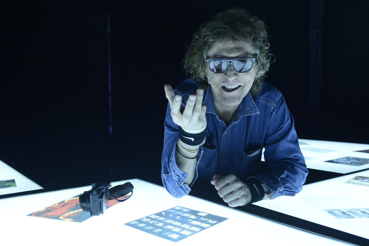 Mick Rock at an illuminated archive table