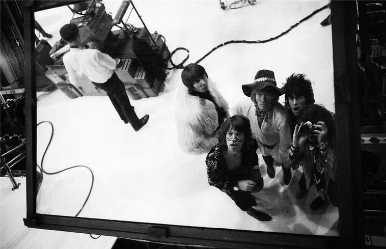 The Rolling Stones reflected in a mirror, London, photographed by Michael Cooper, 1967.