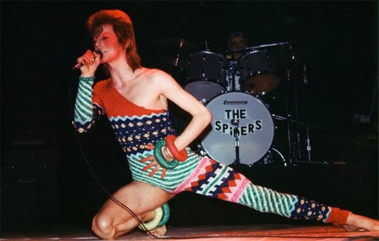David Bowie Kneeling on Stage, United Kingdom, 1973, photographed by Mick Rock.