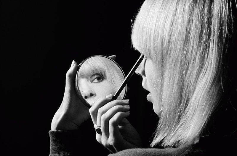 Anita Pallenberg reflected in a makeup mirror, photographed by Michael Cooper, London, 1967.