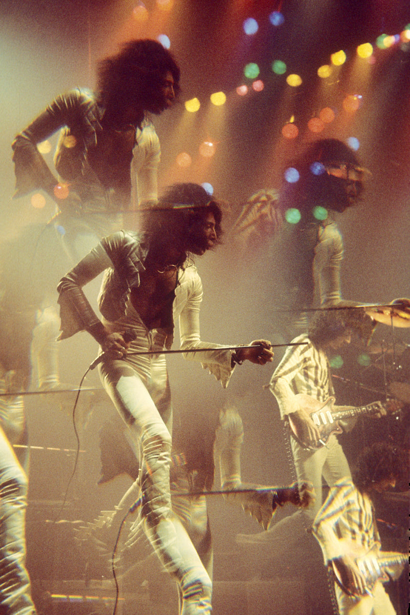 Freddie Mercury of Queen in a multiple-exposure live photograph at the Hammersmith Odeon, London, by Martyn Goddard.