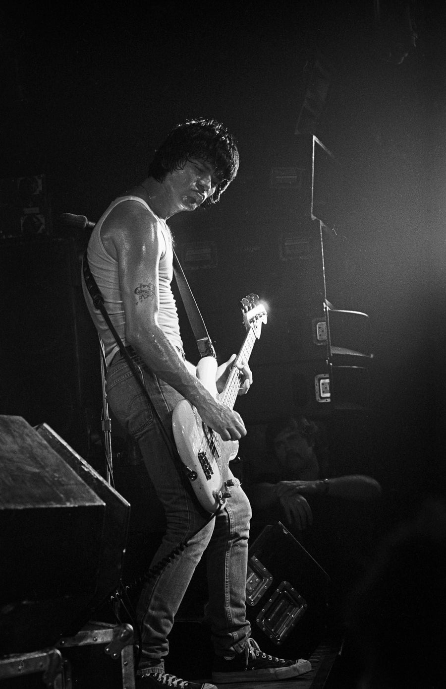 Dee Dee Ramone performing with guitar, Boston, Massachusetts, 1981, photographed by Michael Grecco.