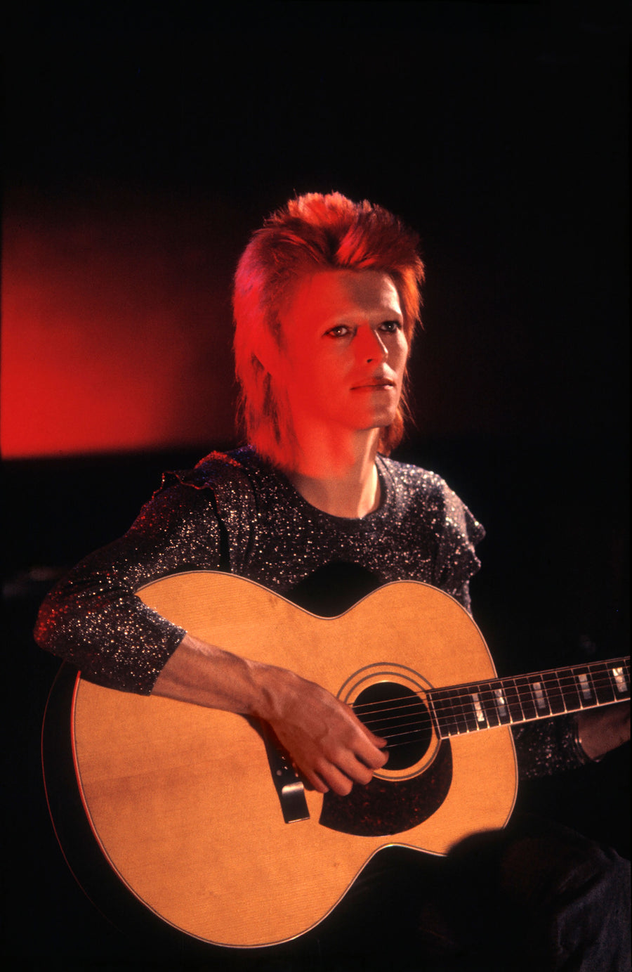 David Bowie with Acoustic Guitar, Haddon Hall, 1972, photographed by Mick Rock.