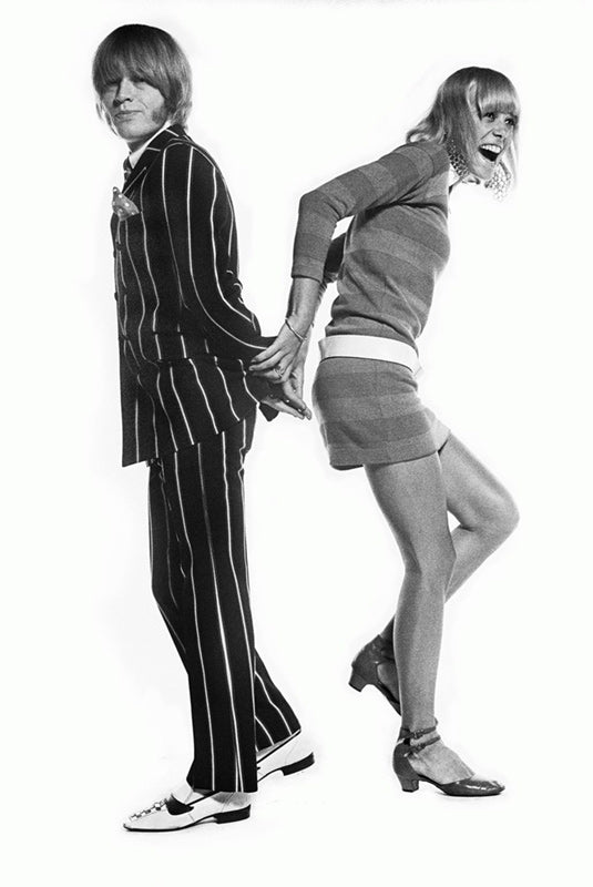 Brian Jones and Anita Pallenberg posed back to back, London, photographed by Michael Cooper, 1966.