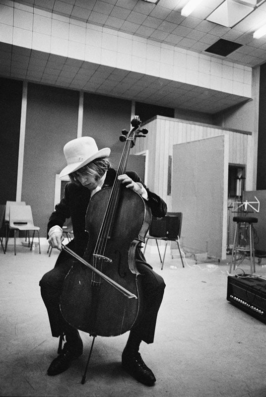 Brian Jones of the Rolling Stones playing cello at Olympic Studios, London, photographed by Michael Cooper, 1966.