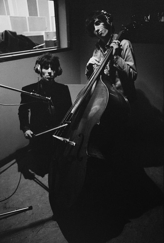 Keith Richards and Bill Wyman playing cello at Olympic Studios, London, photographed by Michael Cooper, 1966.