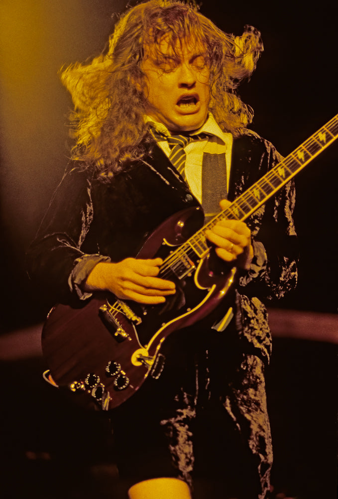 Angus Young of AC/DC, Headbanging, 1983, photographed by Lynn Goldsmith.