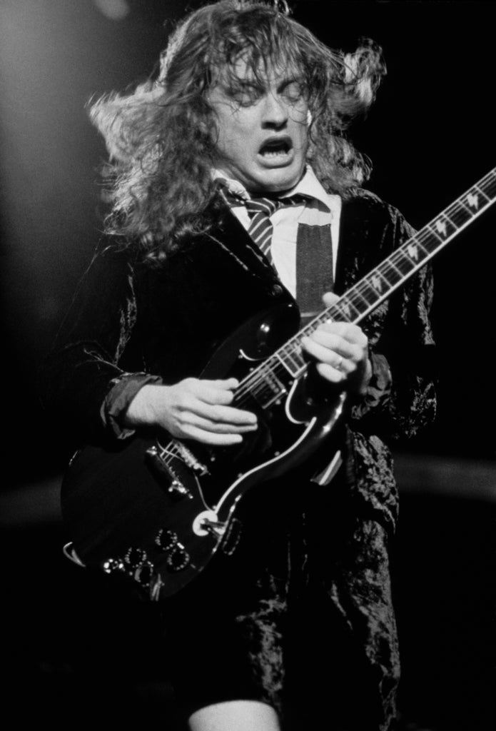 Angus Young of AC/DC, On Stage, 1983, photographed by Lynn Goldsmith.