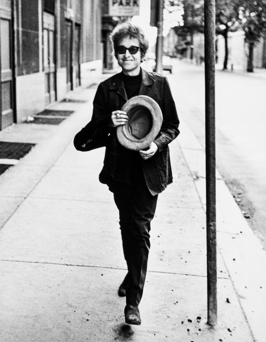 Bob Dylan walking down the street in New York, 1964, photograph by Daniel Kramer