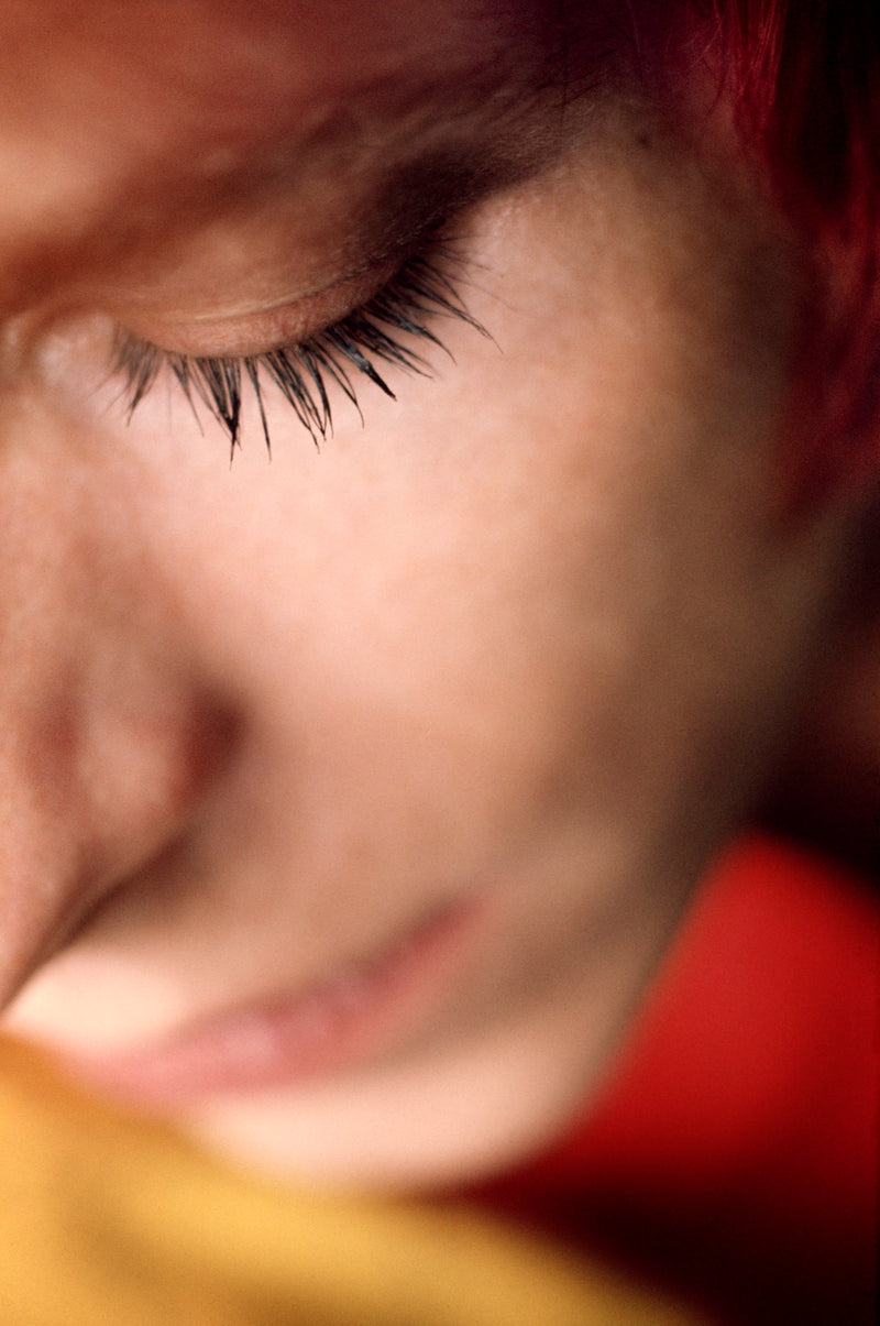 Extreme close-up portrait of David Bowie with eyes closed at Haddon Hall, 1972, photographed by Mick Rock