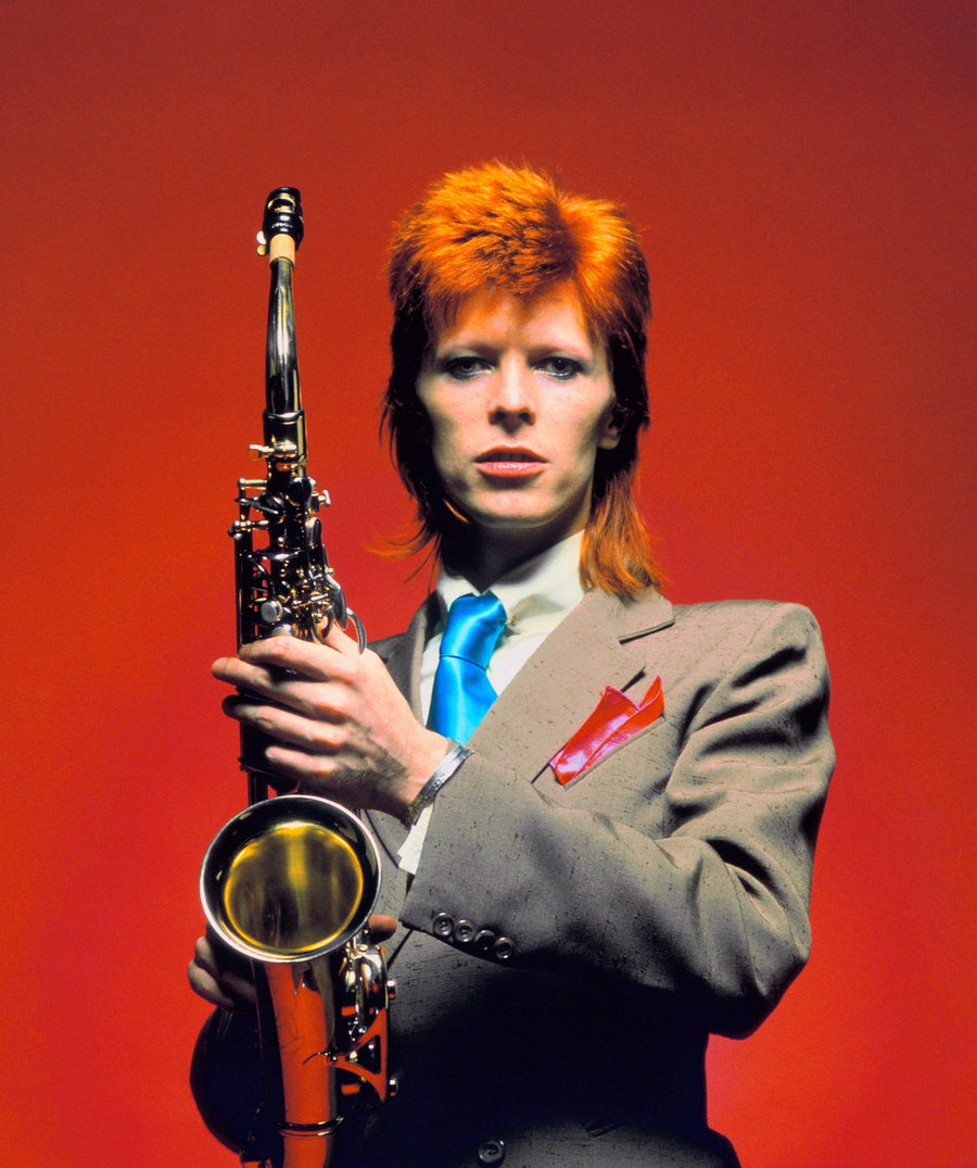 David Bowie with saxophone, London, 1973 — rare color portrait photographed by Mick Rock.