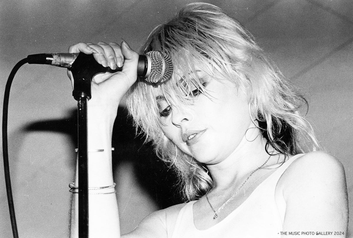 Debbie Harry performing at a microphone, photographed by Ebet Roberts. Unique vintage silver gelatin print.