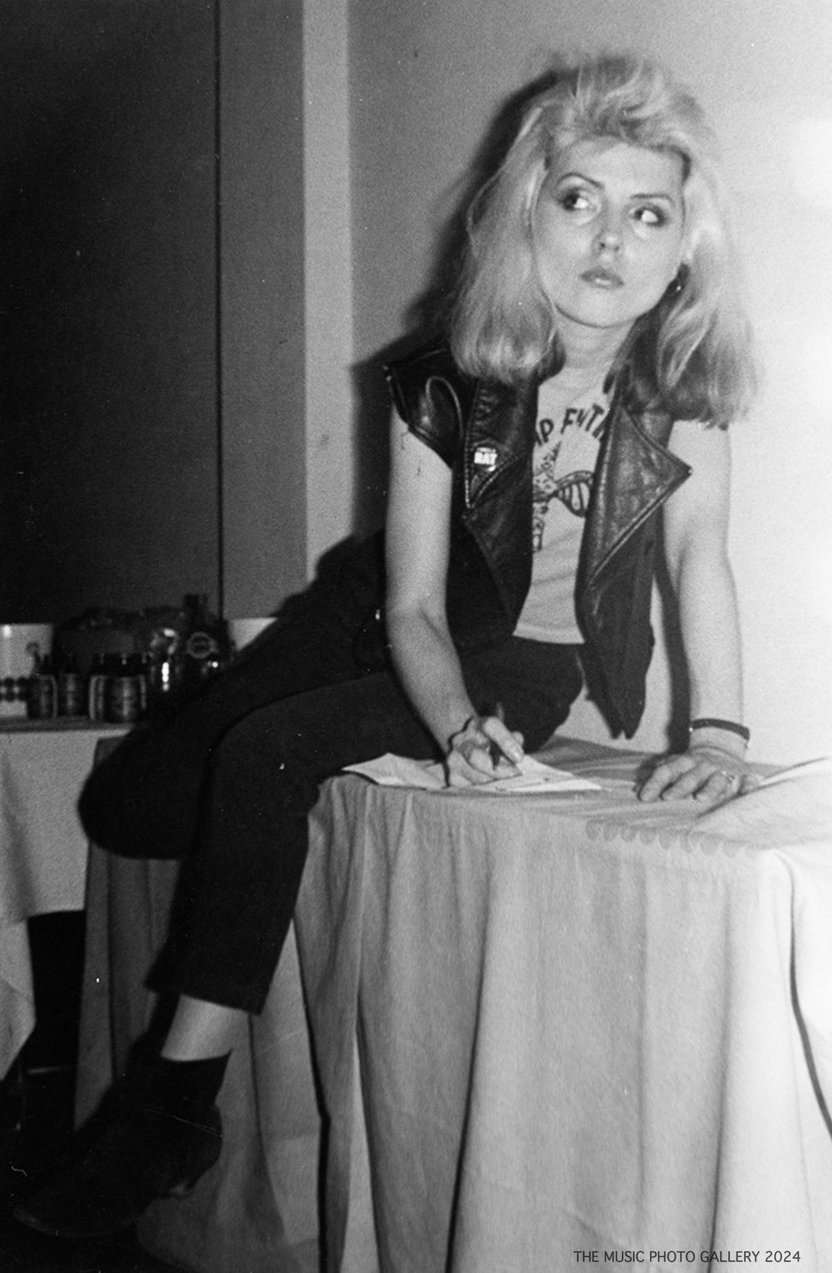 Debbie Harry seated backstage, photographed by Ebet Roberts.