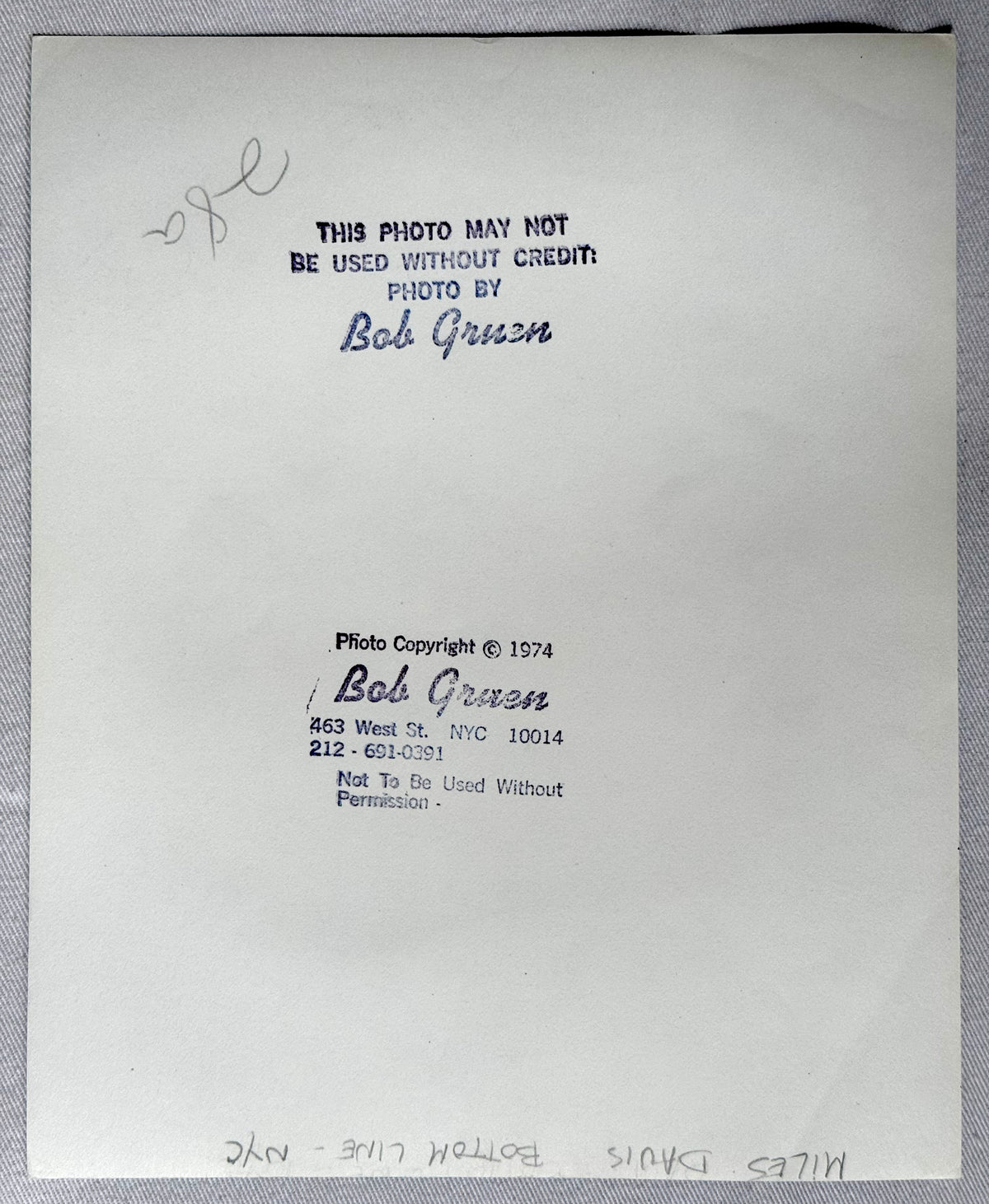 Reverse of the original vintage gelatin silver print of Miles Davis, Bottom Line, New York City, 1974, showing Bob Gruen's credit stamp, 1974 copyright stamp and pencil title.