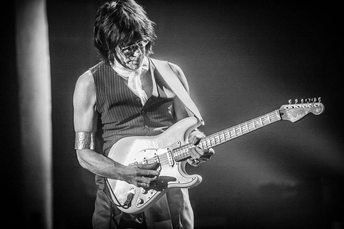 Jeff Beck playing guitar in a spotlight at Uptown Theatre, Napa, California, 2011, photographed by Jérôme Brunet.