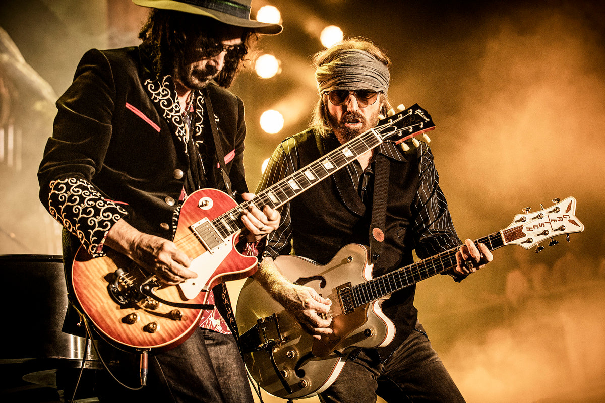 Tom Petty playing guitar alongside a bandmate at BottleRock, Napa, California, 2017, photographed by Jérôme Brunet.