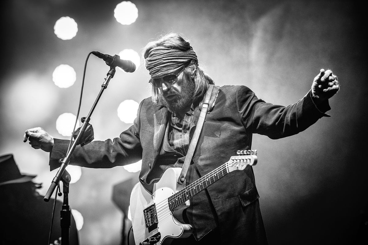 Tom Petty with arms outstretched at the microphone at BottleRock, Napa, California, 2017, photographed by Jérôme Brunet.