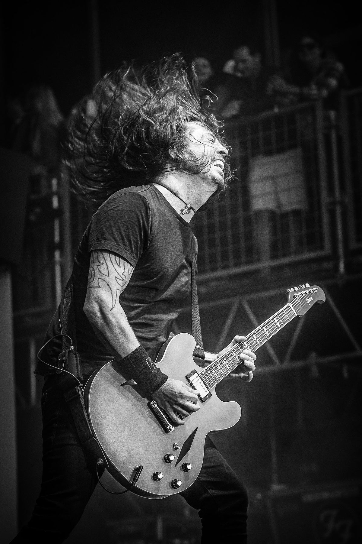 Dave Grohl playing guitar with hair in motion at BottleRock, Napa, California, 2017, photographed by Jérôme Brunet.