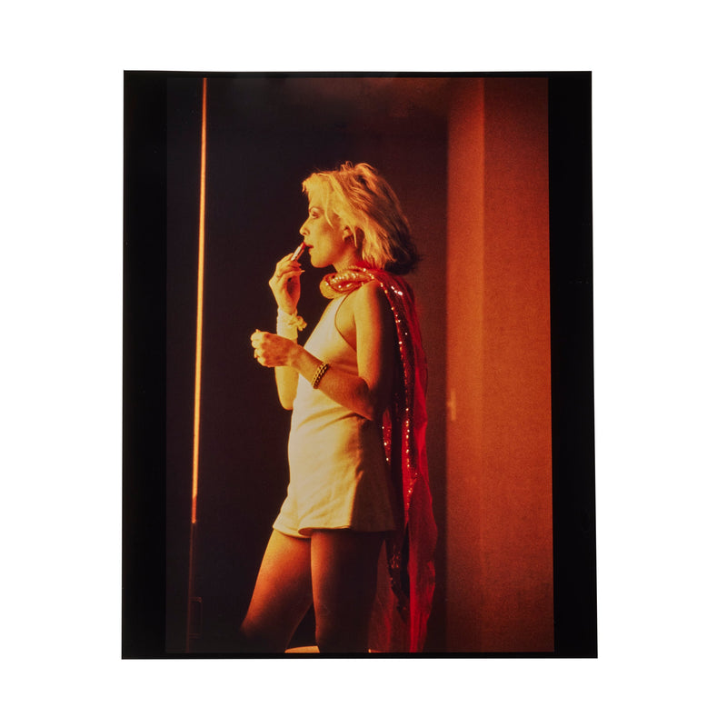 Debbie Harry in profile against Las Vegas neon, lipstick in hand, photographed by Roberta Bayley, 1979.