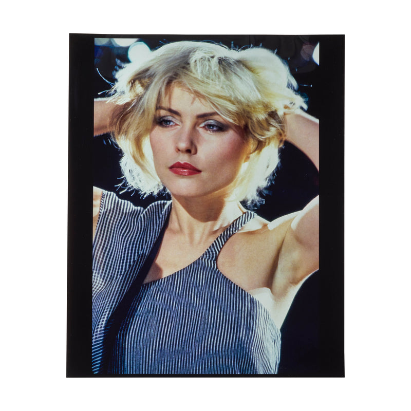 Debbie Harry on the set of Blondie's Heart of Glass video, both hands raised into her hair, photographed by Roberta Bayley, 1978.