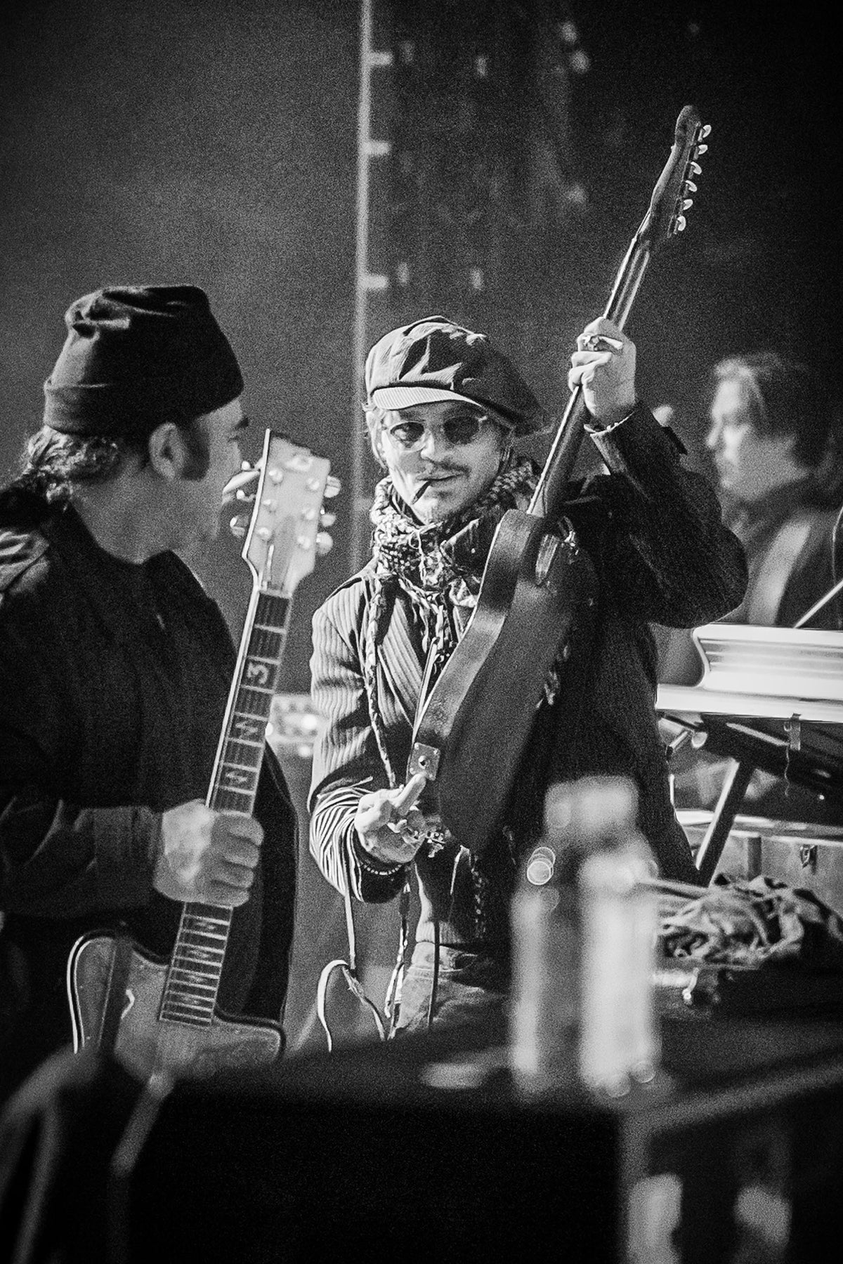Johnny Depp raising his guitar on stage in Anaheim, California, 2020, photographed by Jérôme Brunet.