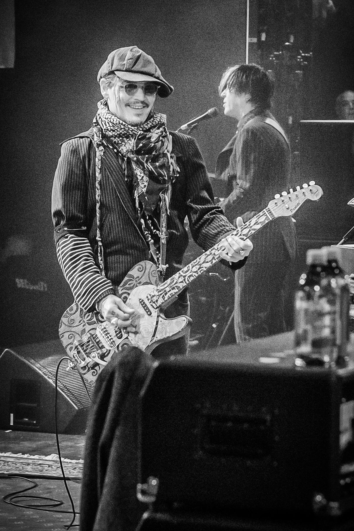 Johnny Depp smiling with his guitar on stage in Anaheim, California, 2020, photographed by Jérôme Brunet.