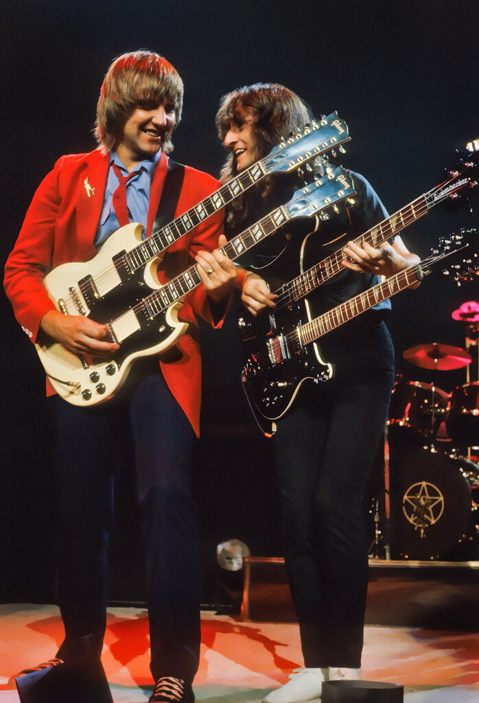 Alex Lifeson and Geddy Lee of Rush with double-neck guitars, in color, 1981, photographed by Lynn Goldsmith.