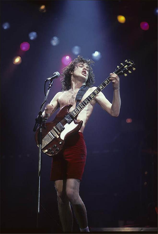 Angus Young of AC/DC performing, photographed by Charlyn Zlotnik, 1980.