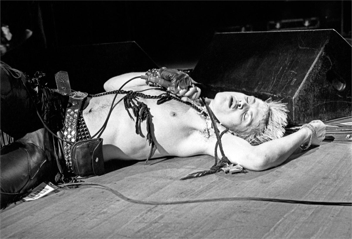 Billy Idol lying on stage at the Capitol Theatre, Passaic, New Jersey, 1984, photographed by Mark Weiss.