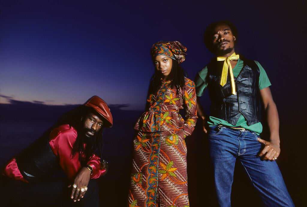 Black Uhuru against a deep blue evening sky, in color, 1982, photographed by Lynn Goldsmith.
