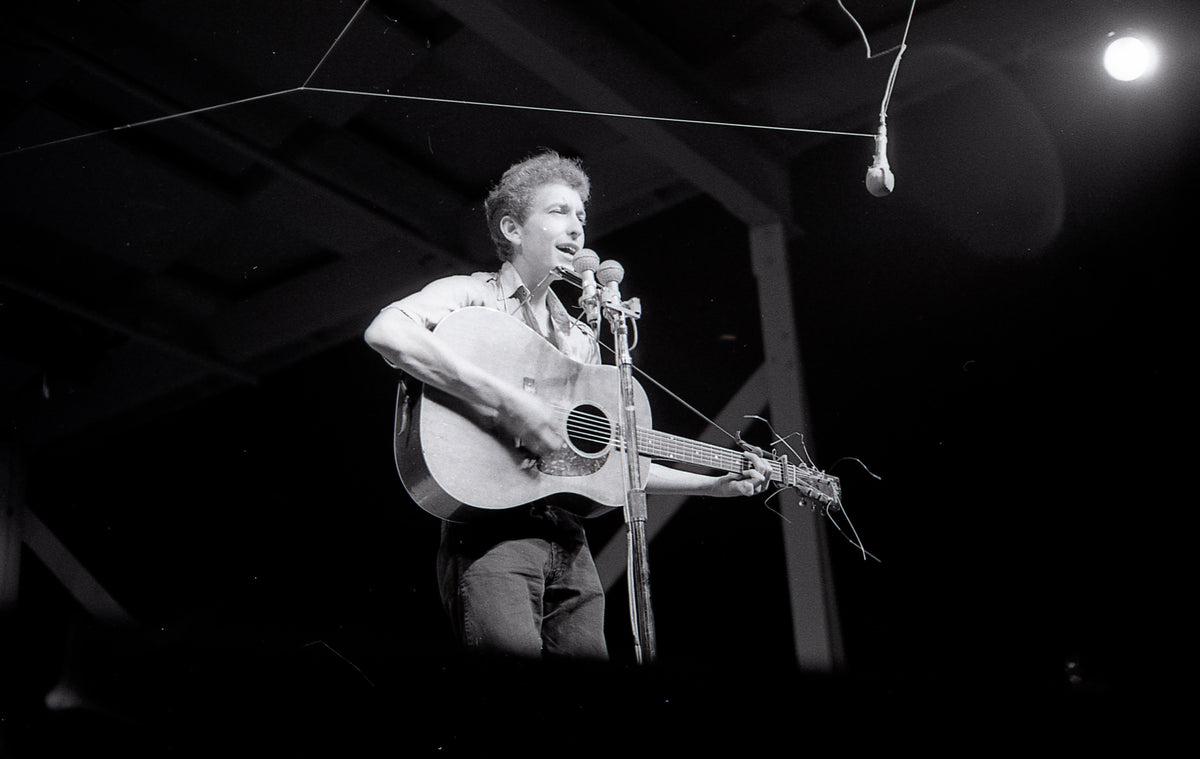 Bob Dylan Under the Stage Lights, Newport Folk Festival, Newport, Rhode Island, July 1963; photograph by John Byrne Cooke.