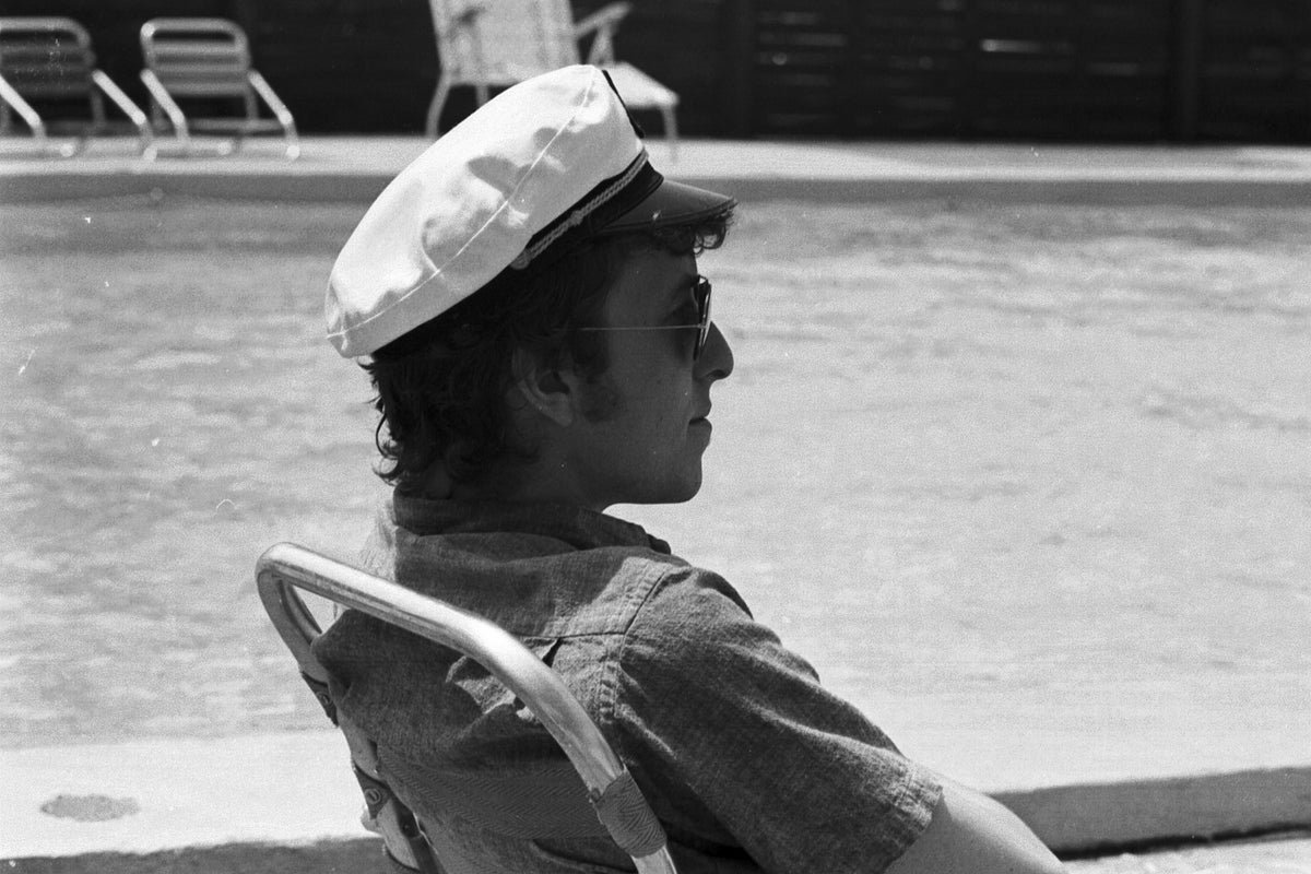 Bob Dylan in a Captain's Cap, Viking Hotel, Newport, Rhode Island, July 1964; photograph by John Byrne Cooke.