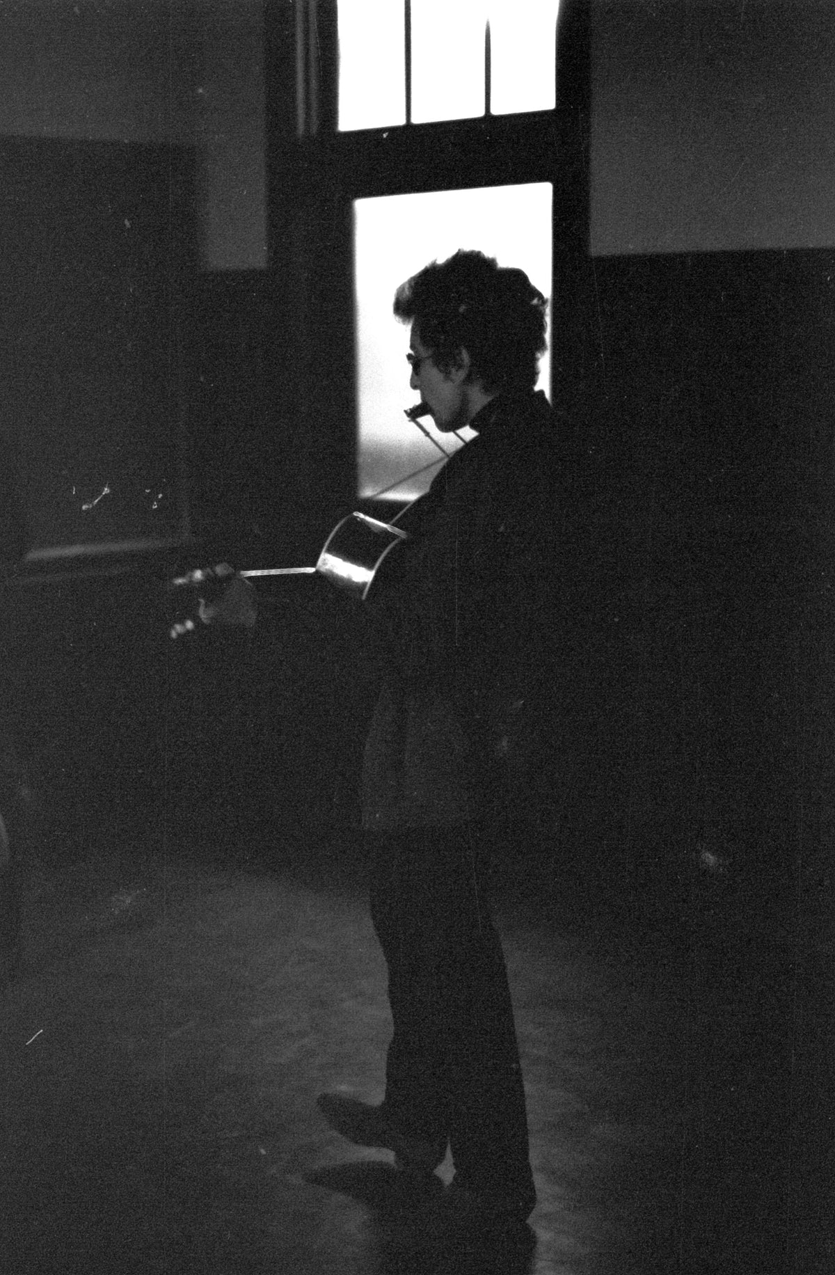 Bob Dylan in Silhouette, University of Massachusetts, Amherst, Massachusetts, April 26, 1964; photograph by John Byrne Cooke.